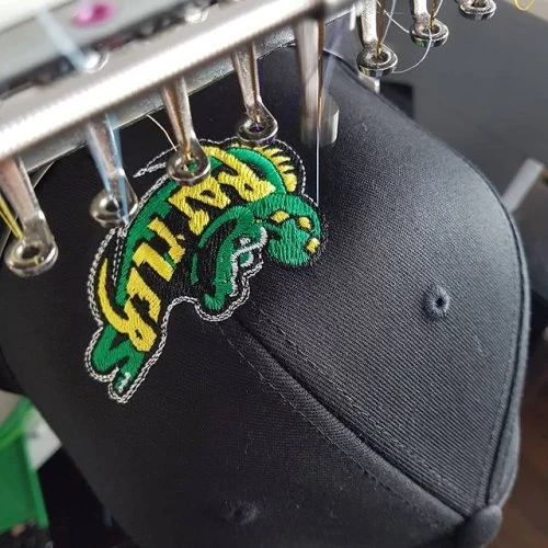 #rattlers getting their hat on! This is a cool logo embroidered onto a flexfit cap! #customcaps #embroideredhats #flexfit